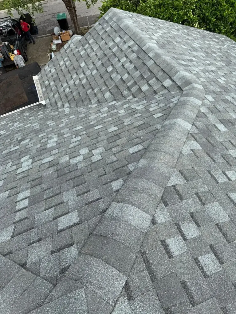 After roof photo of ridge line and hip detail showing Atlas Pinnacle Pristine Coastal Granite shingles installed by Integrity Roof Services in Orlando, FL.