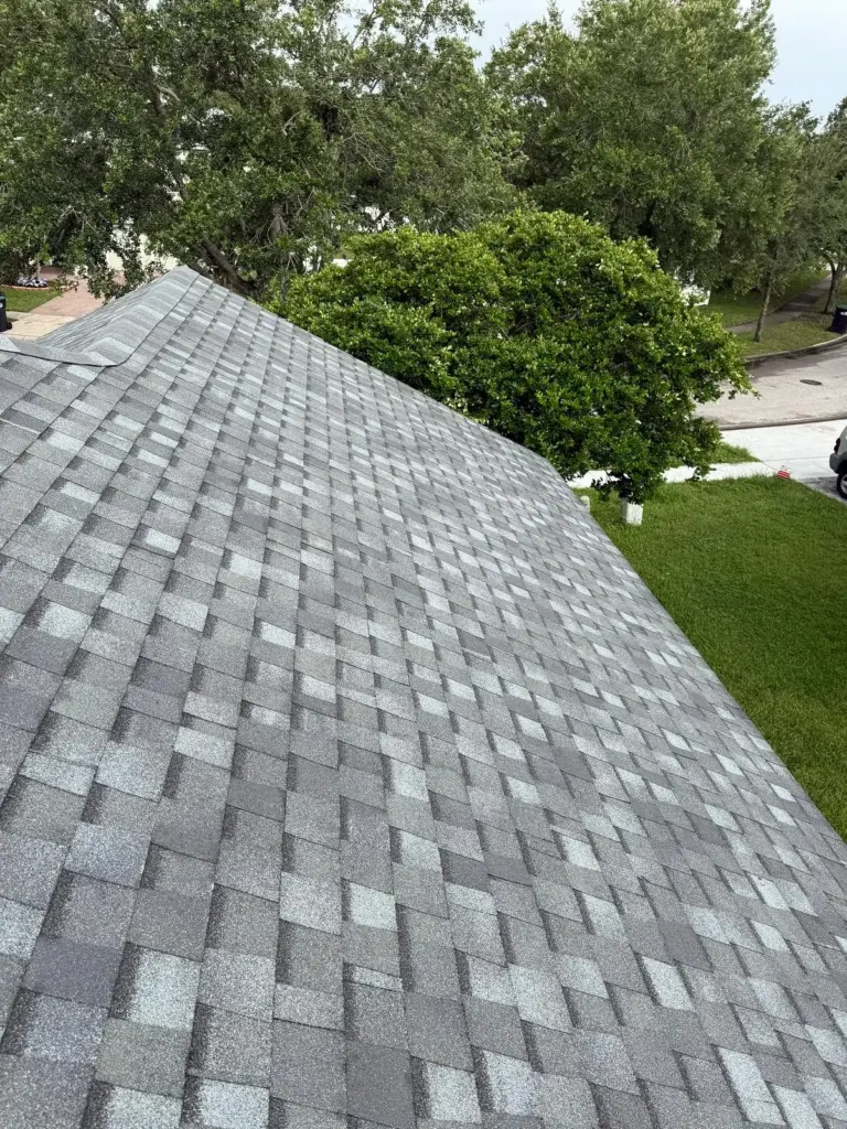 After roof photo of front elevation showing new Atlas Pinnacle Pristine Coastal Granite shingles installed by Integrity Roof Services in Orlando, FL.