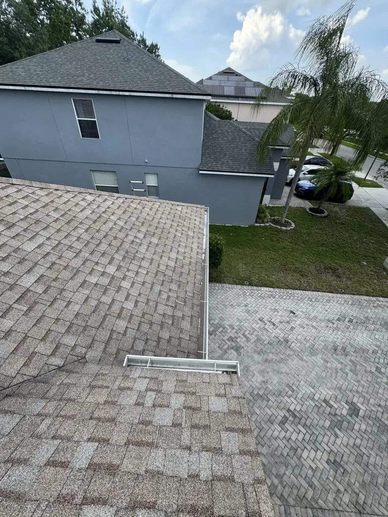 Before roof photo of valley metal detail showing Atlas Pinnacle Pristine Coastal Granite shingles installed by Integrity Roof Services in Orlando, FL.