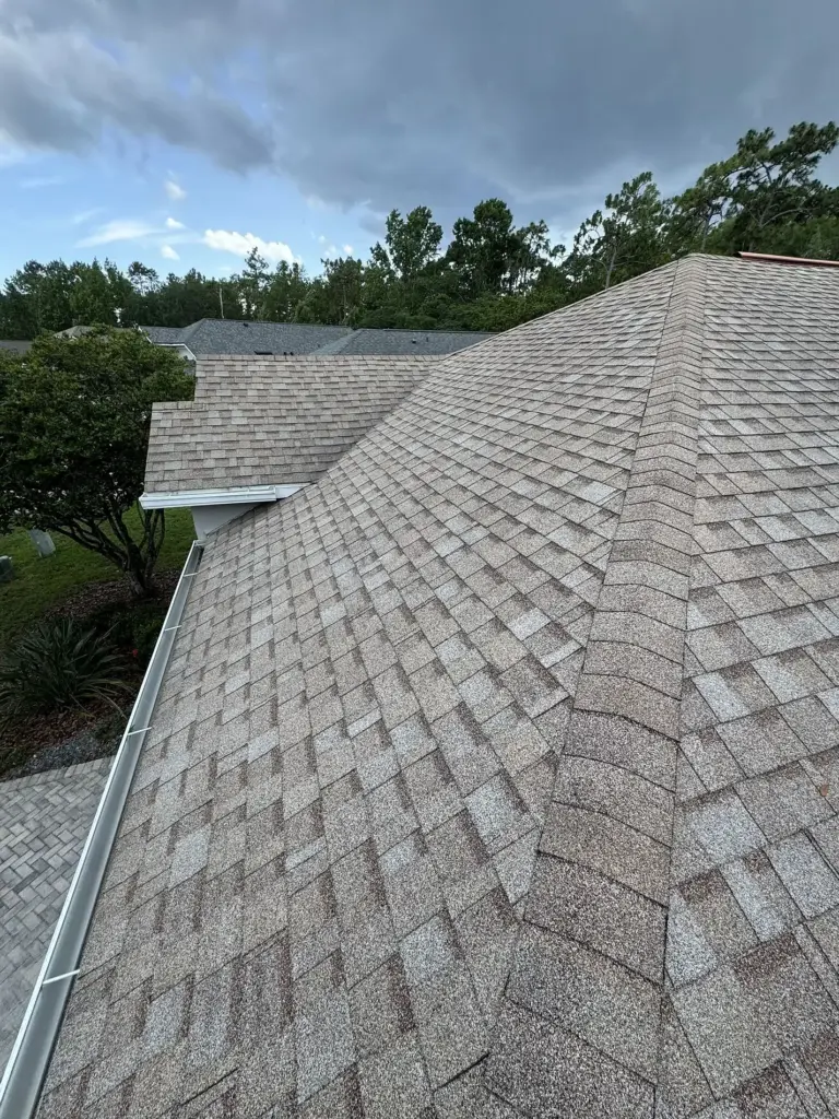Before roof photo of left slope showing Atlas Pinnacle Pristine Coastal Granite shingles installed by Integrity Roof Services in Orlando, FL.