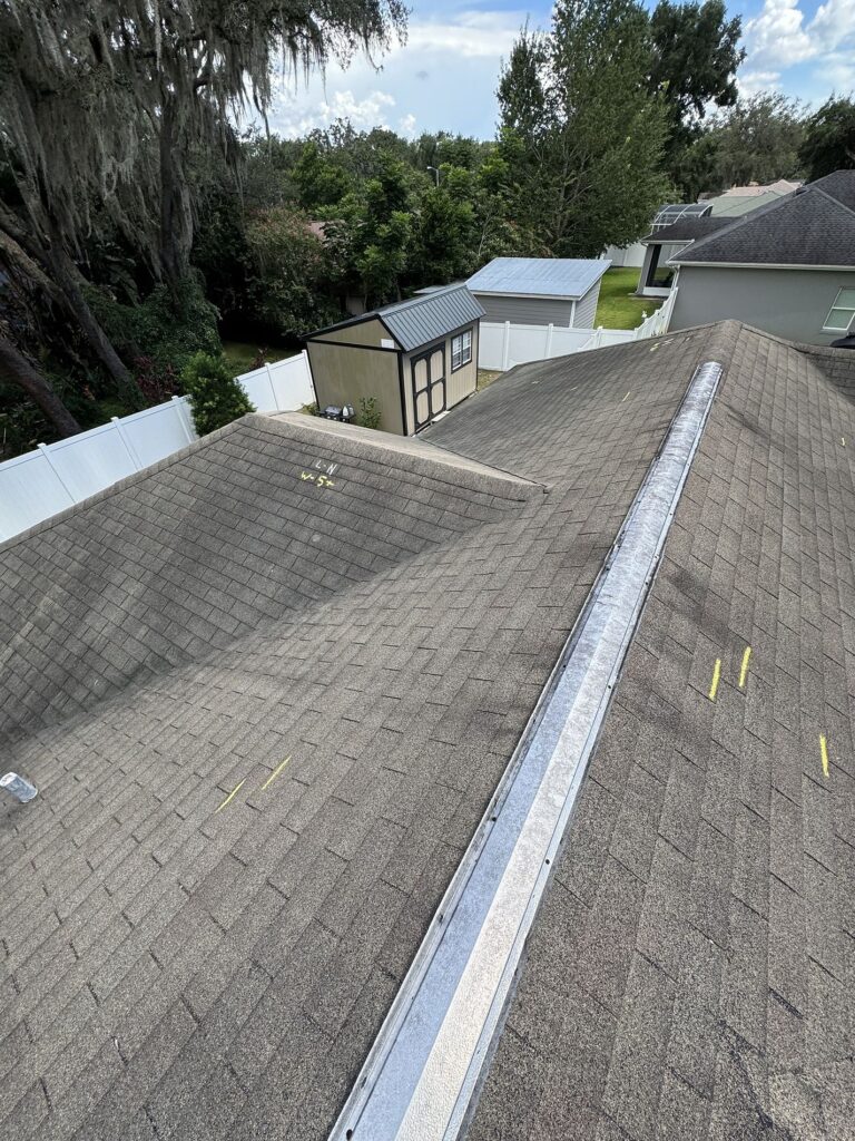 Roofing Projects FL 4 Worn asphalt shingles with storm impact before Atlas roof replacement — Integrity Roof Services, Longwood FL.