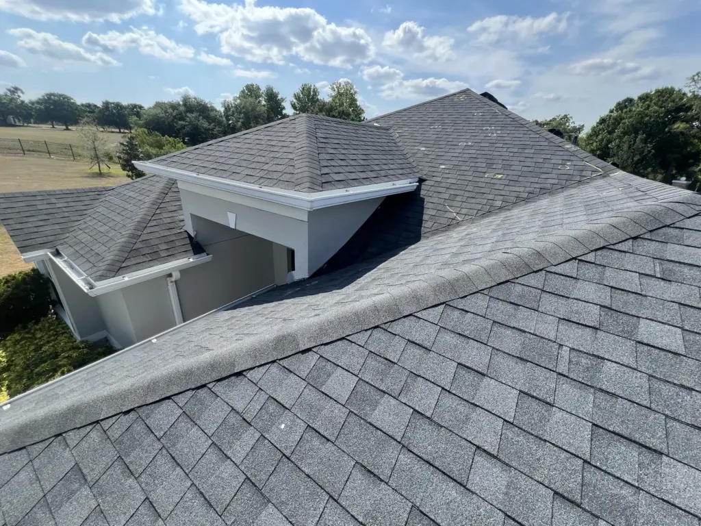 Roofing Projects FL 8 Failing ridge and worn shingles across upper roof section