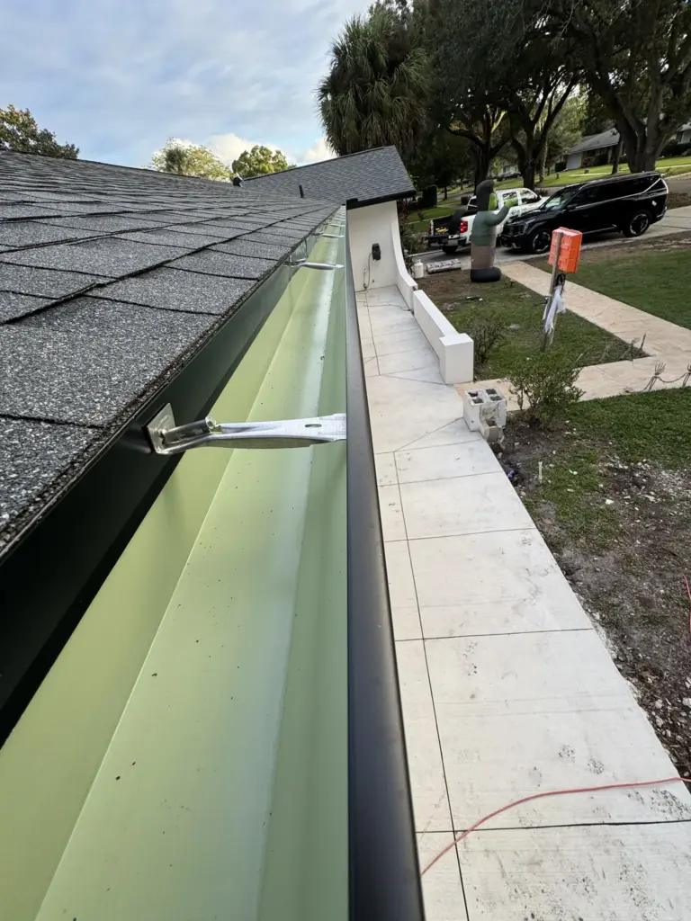 Integrity Roof Services professional install of the guuter edge showing correct overlap of shingles with flashing