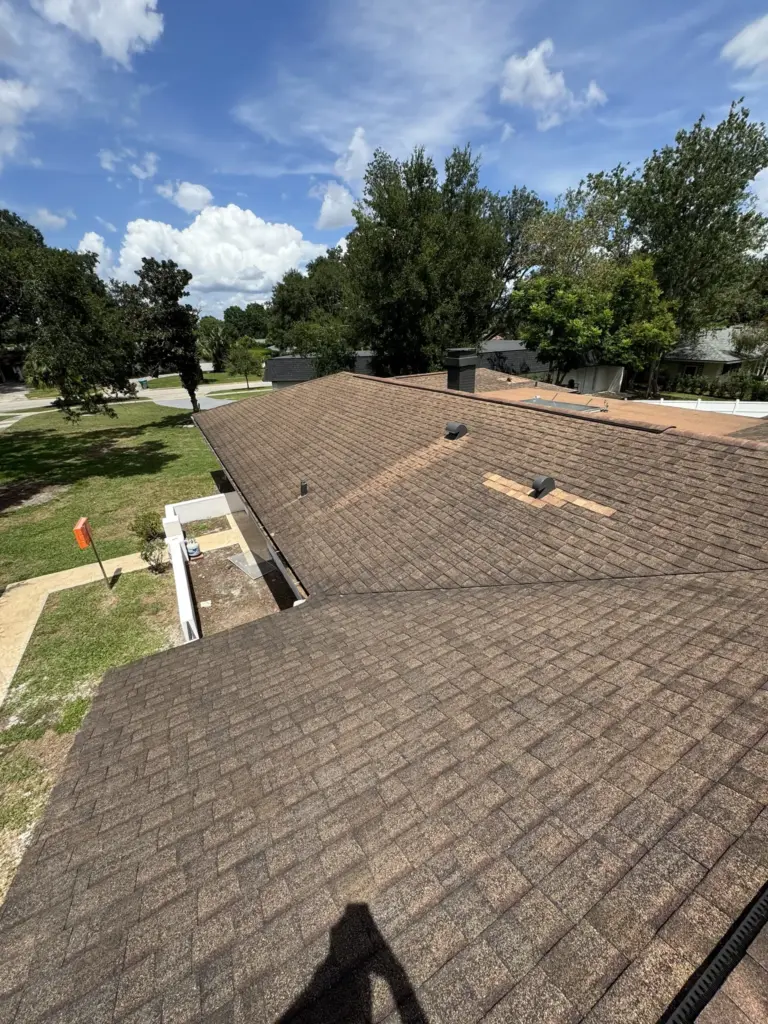 Winter Park FL residential roof showing age, staining, and storm-related damage before repairs.