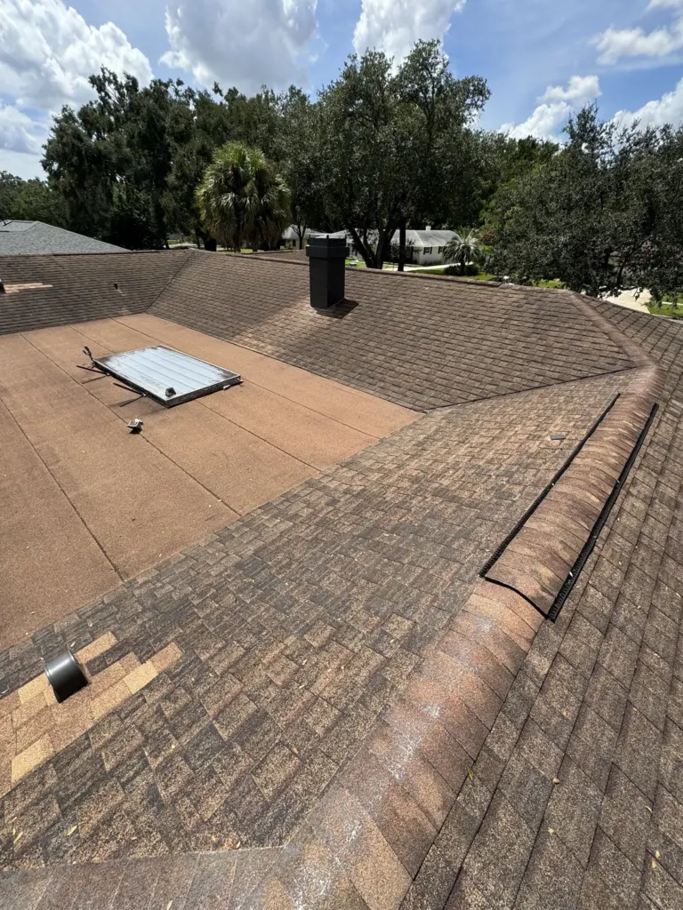 Close-up of deteriorated asphalt shingles with storm impact — Winter Park FL roofing assessment.