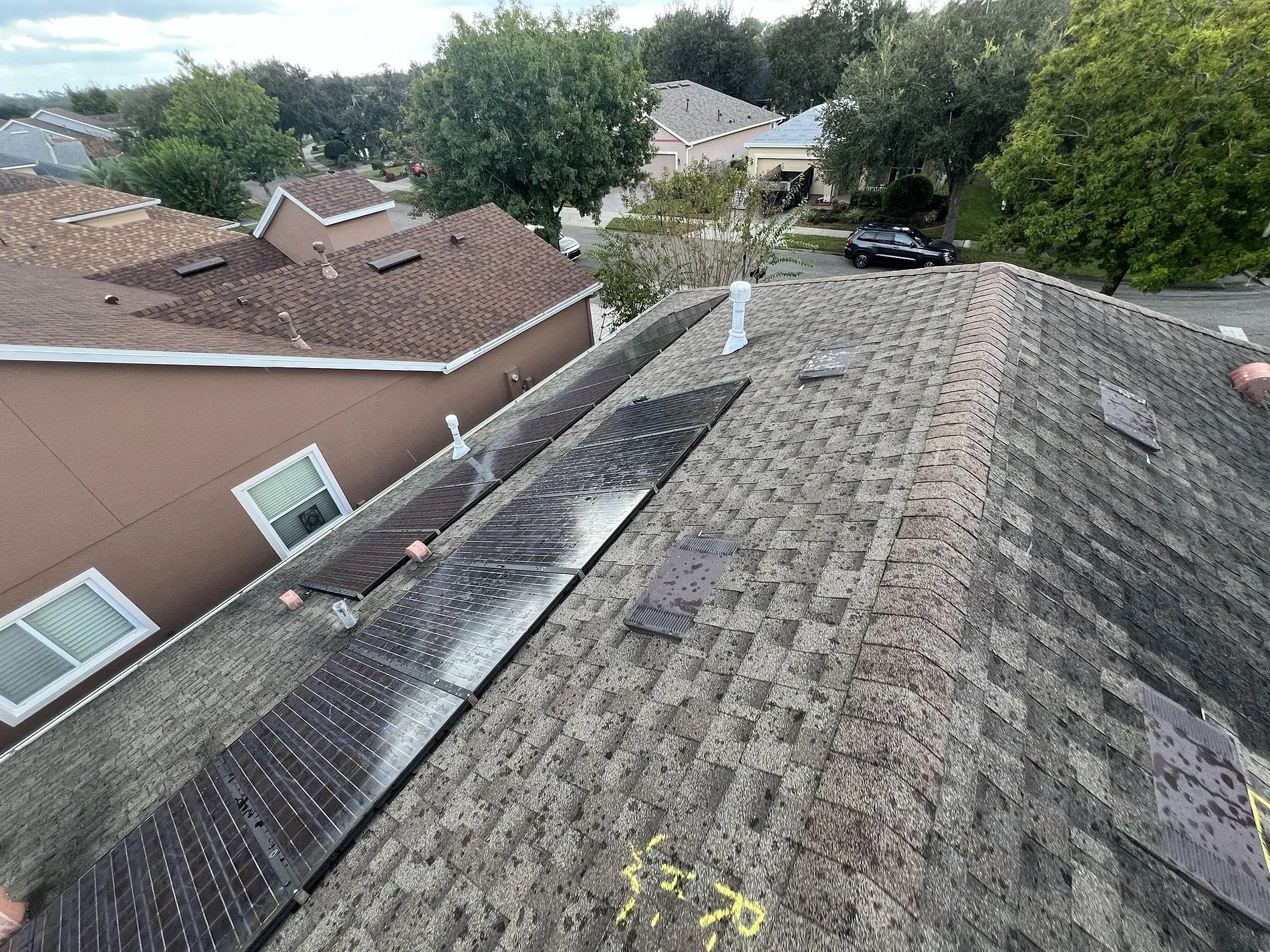 Severe Hail-Damaged Roof Replacement in DeLand, FL 2 Storm and hail damage along roof plane showing soft spots and compromised shingle integrity before replacement