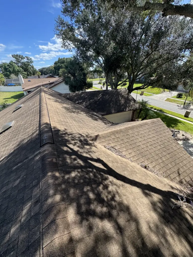 Roofing Projects FL 35 Roof slope showing widespread storm damage and aging materials contributing to active leaks.