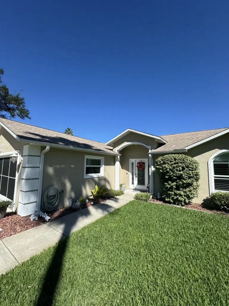 Roofing Projects FL 24 Front of home showing gutters and asphalt shingles before roof replacement in Port Orange Florida