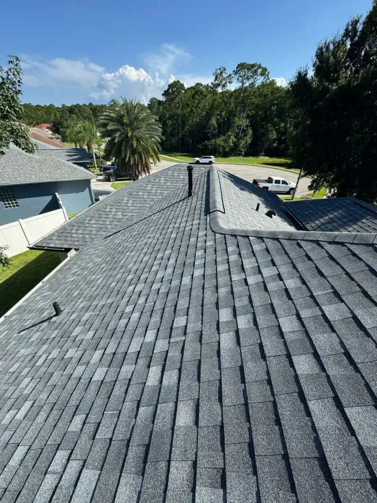 New black gooseneck exhaust vent installed on Atlas Pinnacle Pristine Pewter shingles in Port Orange, FL.