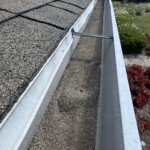 Gutters collecting shingle stone Gutters with shigle grainulas before Integrity Roof Services Umatilla, FL 32784