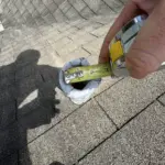 Old plumbing vent and flashing before repairs — cracked sealant and rusted collars scheduled for Bullet Boot Pipe Flashing replacement. Old plumbing vent and flashing before repairs — cracked sealant and rusted collars scheduled for Bullet Boot Pipe Flashing replacement.