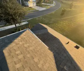 Back roof slope showcasing completed shingle installation with upgraded ventilation on a Mount Dora, FL home after storm damage replacement Rear slope showing full shingle replacement