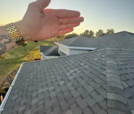 Inspector shading you across newly installed Weathered Wood shingles during final roof inspection in Mount Dora, FL Inspector shading you from the sun toward newly installed slope
