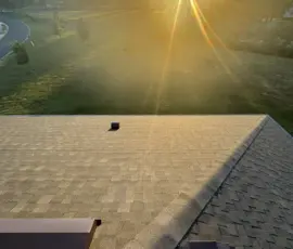 Sunset shining across newly installed Atlas Pinnacle Pristine Weathered Wood shingles on Mount Dora, FL home. Sunset over newly installed Weathered Wood shingles