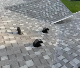 Ridge lines completed with matching architectural components. Clean ridge lines on completed roof installation in Port Orange FL