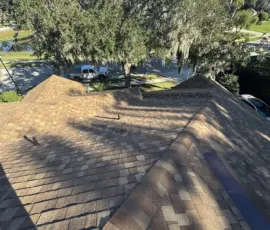 Completed roof installation featuring architectural shingles in Sanford, FL. Newly installed architectural asphalt shingles on residential roof in Sanford, Florida