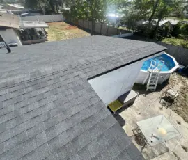 Completed roof replacement showing the finished Black Shadow shingles and black metal edge detail. Finished Roof Replacement with Black Drip Edge in Daytona Beach Florida