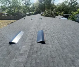 New Atlas Black Shadow roof installation featuring off-ridge ventilation and a clean finished surface. New Black Shadow Architectural Shingle Roof with Off-Ridge Vents