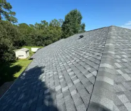 Finished Atlas Pewter roofline with new hip-and-ridge shingles and ridge ventilation. Completed Atlas Pinnacle Pristine Pewter shingles and ridge ventilation on Lancers Lane in Port Orange, FL.