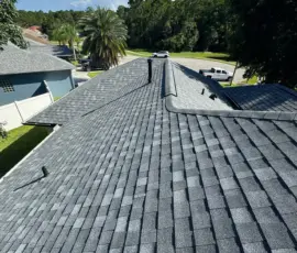 New black gooseneck exhaust vent integrated into the completed Atlas Pewter roofing system. New black gooseneck exhaust vent installed on Atlas Pinnacle Pristine Pewter shingles in Port Orange, FL.