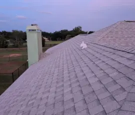 Completed Roof Shingles and White Vent Pipe at Dusk